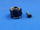 A black top cap cover with plastic spacers of different sizes, intended for bicycle headset maintenance.