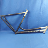 A used Cortina Indigo lady's bike frame with a alloy frame, displayed against a blue background.
