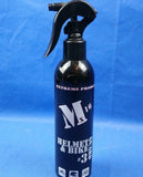 A black spray bottle labeled 'MX 16 Helmet & Bike Cleaner Guard' with white and gray text on a blue background, indicating it is a product for cleaning motorcycle and helmet surfaces.