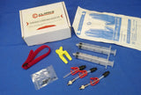 A set of bicycle brake bleed kit components including adaptors, syringes, a block with tubing, a Valcro tie, and gloves, packaged in a white box with red and blue accents.