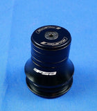 Black FSA Bicycle Threadless Headset with Spacers laid out on a blue background