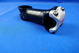 FSA XC150 Bicycle Stem, mostly black with silver accents, viewed from the side against a blue background.