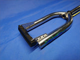A silver chrome front fork for 16 inch wheels with some signs of use, placed against a blue background.