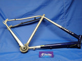 A used Gazelle Charmonix Hybrid Bike frame with a 23 inch alloy frame and 28 inch wheels, predominantly silver with blue accents, displayed on a blue background.